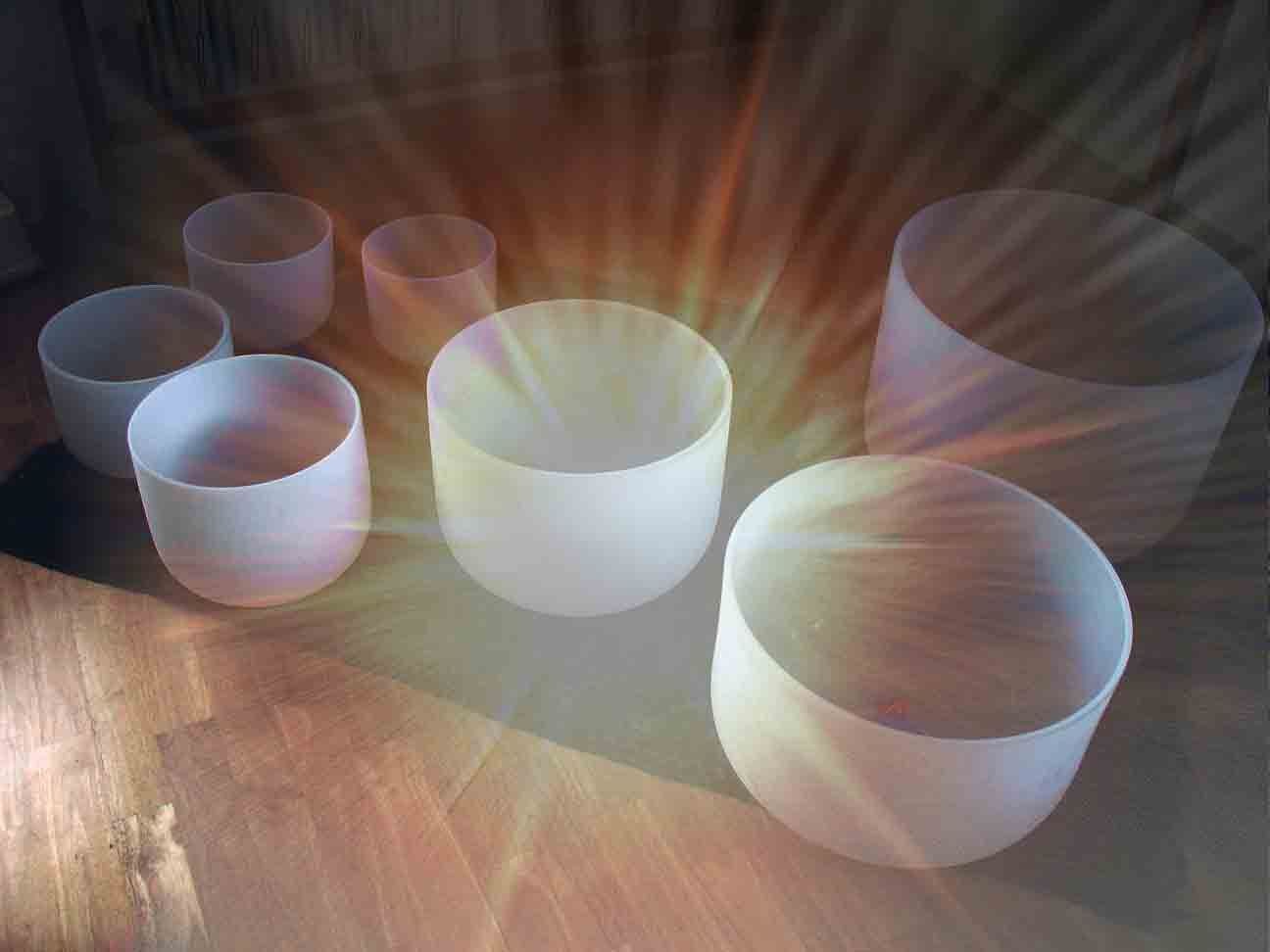 Crystal singing bowls used in sound healing sessions at The Art of Massage and Yoga Therapy